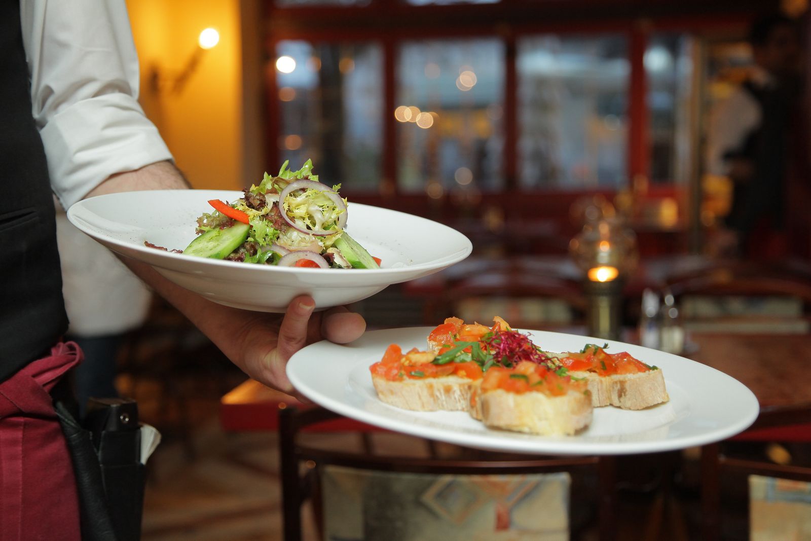 The Corniche Room fine dining restaurant with white tablecloths and warm ambient lighting